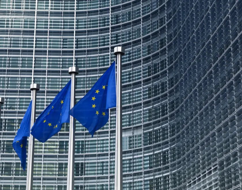 EU flags outside a large building