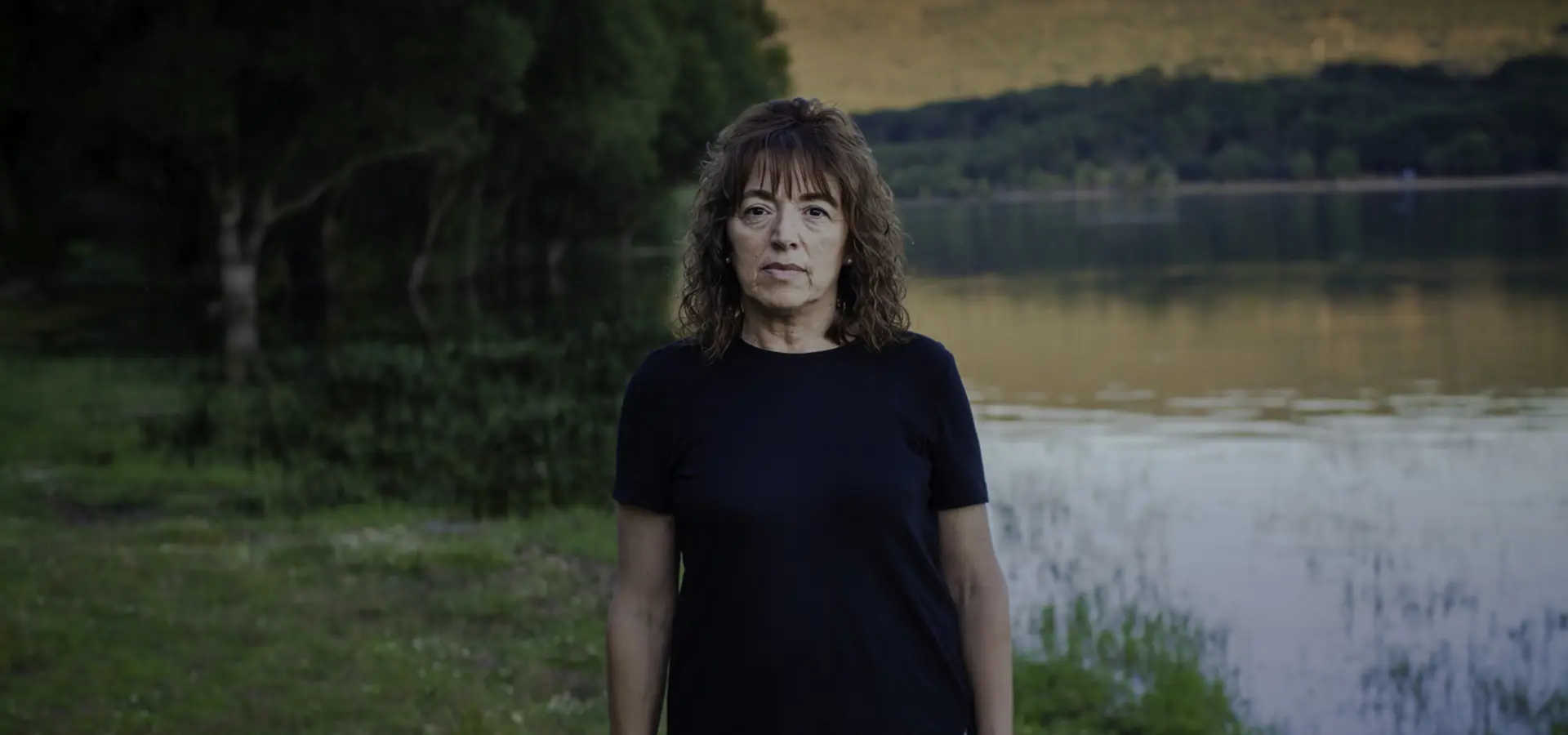 Woman in field near reservoir in Spain