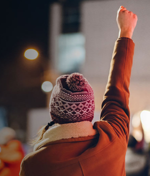 Woman raising her first in protest